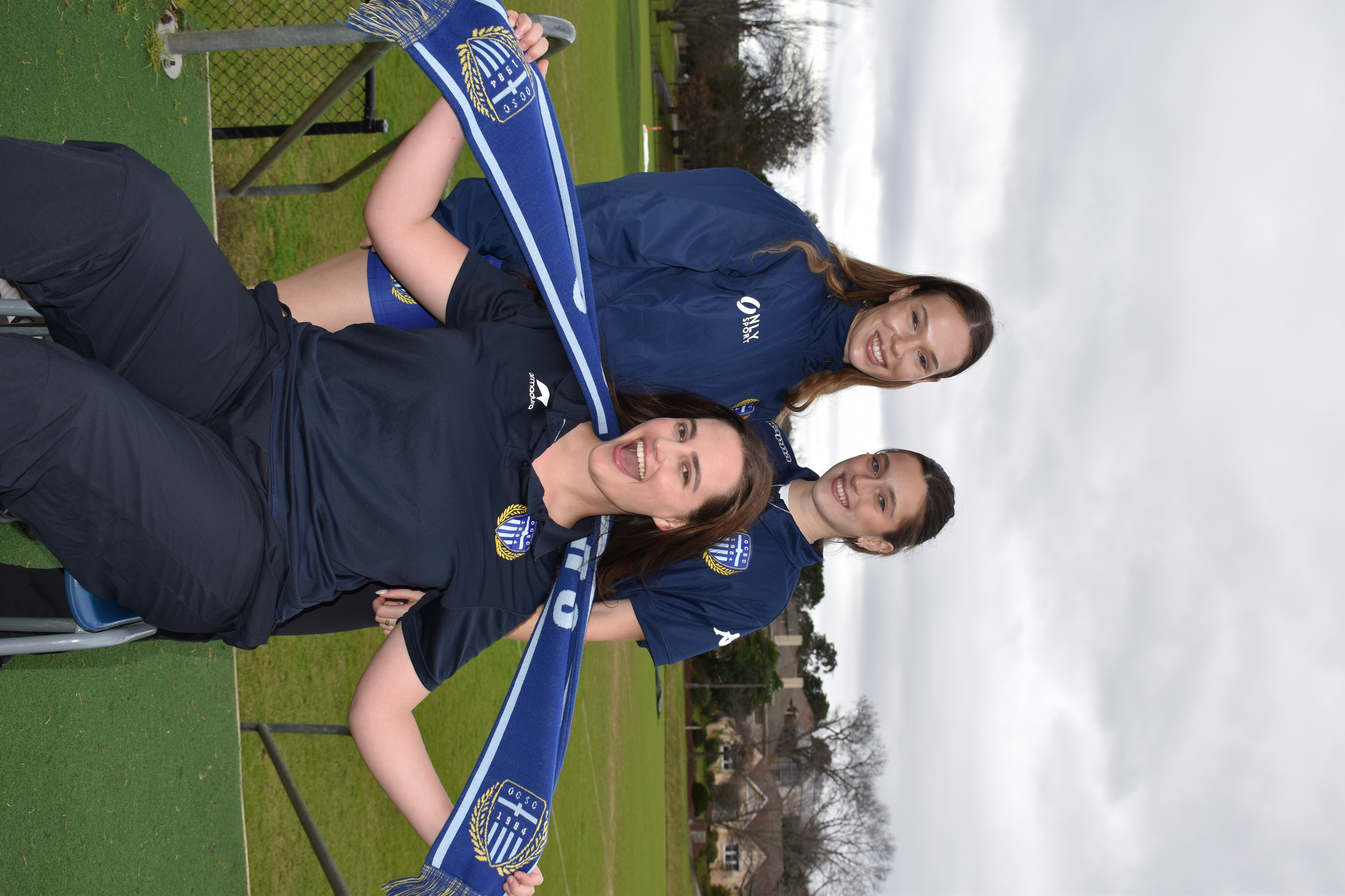 Members wearing the club scarf pitch-side
